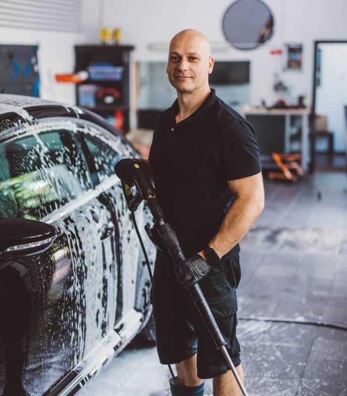 service-man-washing-car-before-detailing-in-workshop-.jpg